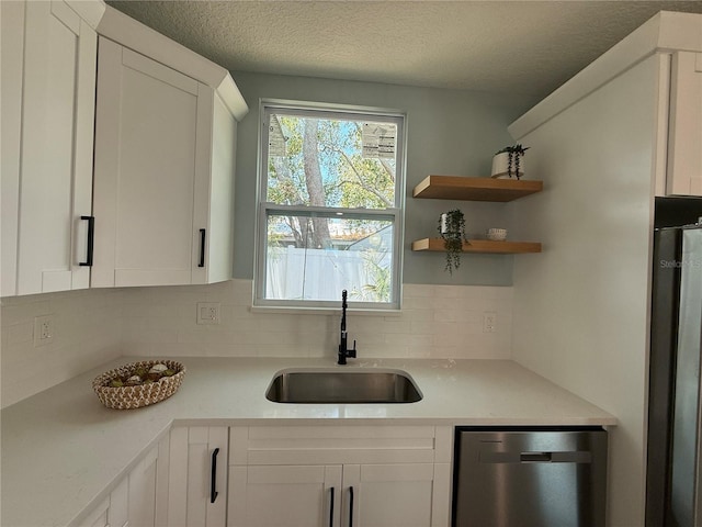 110 Kenwood Ave, Clearwater, FL 33755 - kitchen featuring a sink, dishwasher, tasteful backsplash, light countertops, and a textured ceiling