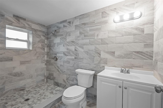 660 Palm Ave, Tarpon Springs, FL 34689 - bathroom with toilet, a tile shower, vanity, and tile walls