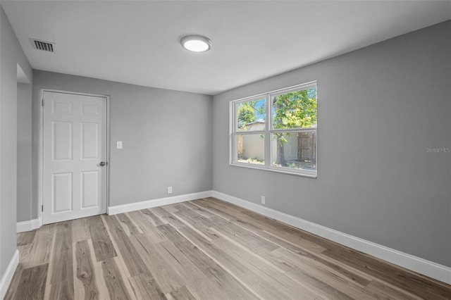 660 Palm Ave, Tarpon Springs, FL 34689 - unfurnished room with visible vents, wood finished floors, and baseboards