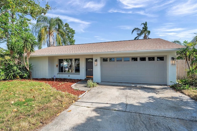 ranch-style house with brick siding, driveway, and an attached garage