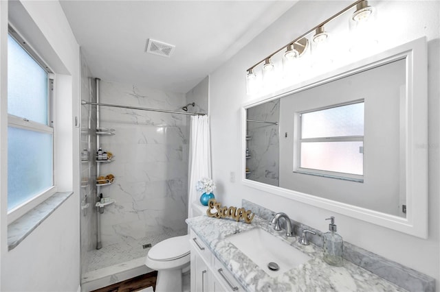 full bathroom with visible vents, toilet, vanity, and a marble finish shower