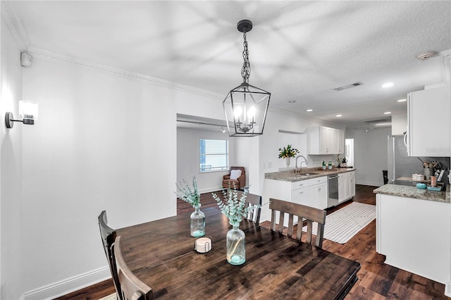 dining room featuring a chandelier, visible vents, ornamental molding, and dark wood-type flooring