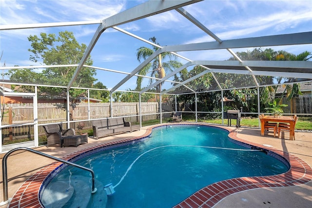 view of swimming pool with a patio, a lanai, a fenced backyard, and a fenced in pool