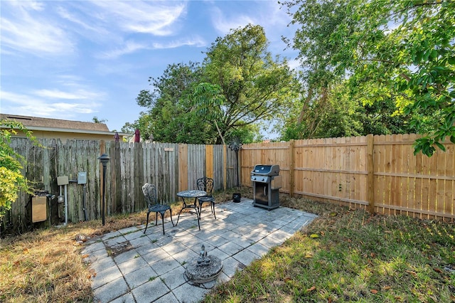 view of patio / terrace featuring a fenced backyard and a grill