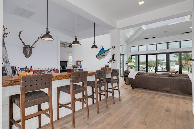 kitchen featuring hanging light fixtures, light wood-type flooring, open floor plan, and visible vents
