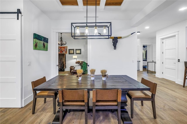 dining space featuring light wood-type flooring, recessed lighting, beam ceiling, and a notable chandelier