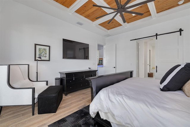 bedroom featuring a barn door, light wood-style flooring, wooden ceiling, and beamed ceiling