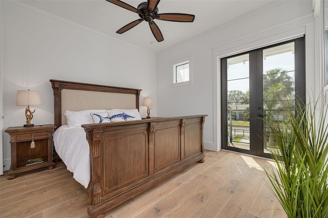 bedroom with light wood-style floors, access to outside, ornamental molding, and french doors