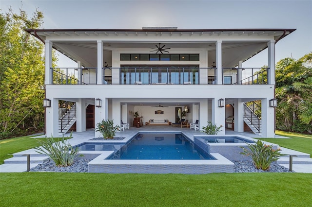 rear view of property featuring a ceiling fan, a patio, a yard, and stairway