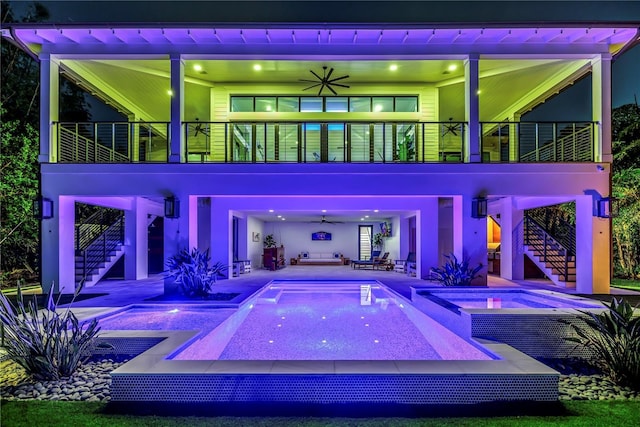 view of swimming pool with stairway, a patio, a pool with connected hot tub, and a ceiling fan