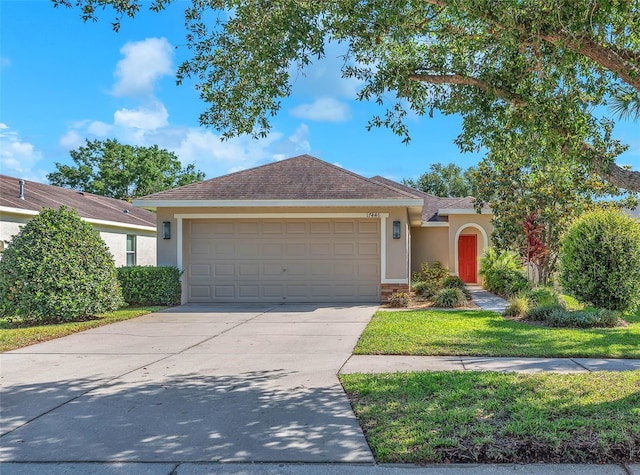 ranch-style home featuring concrete driveway, stucco siding, an attached garage, and roof with shingles