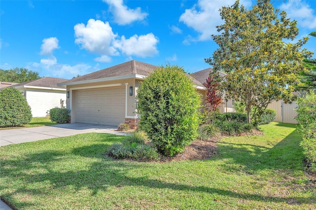 view of front facade featuring fence, a front lawn, concrete driveway, an attached garage, and stucco siding