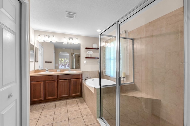 bathroom with a garden tub, visible vents, tile patterned flooring, a shower stall, and a sink