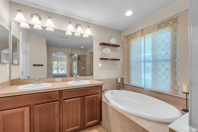 bathroom with double vanity, a sink, a bath, and a shower stall