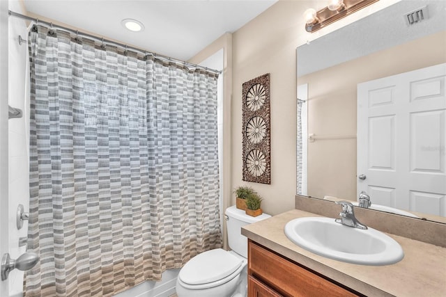bathroom featuring toilet, visible vents, curtained shower, and vanity