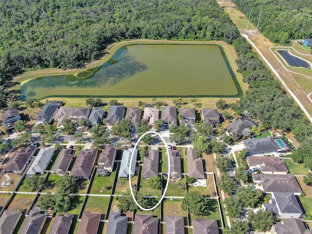 birds eye view of property with a residential view, a water view, and a wooded view