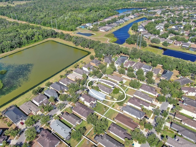 birds eye view of property with a water view, a residential view, and a forest view