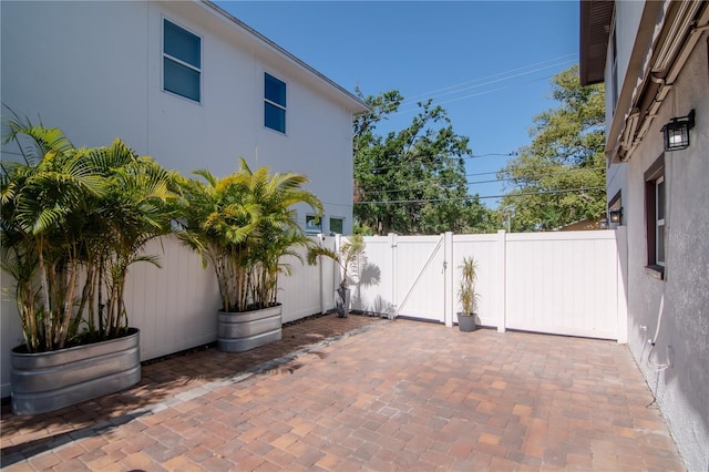 view of patio with a fenced backyard and a gate