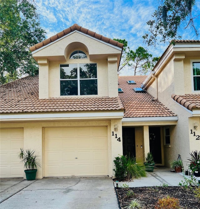 114 Clays Trl Unit 114, Oldsmar, FL 34677 - view of front of home featuring a tiled roof, concrete driveway, and stucco siding