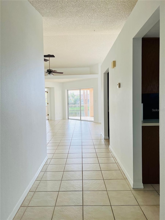 114 Clays Trl Unit 114, Oldsmar, FL 34677 - corridor with light tile patterned floors, a textured ceiling, and baseboards