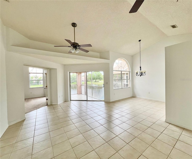 114 Clays Trl Unit 114, Oldsmar, FL 34677 - empty room featuring ceiling fan, a chandelier, light tile patterned floors, lofted ceiling, and a textured ceiling
