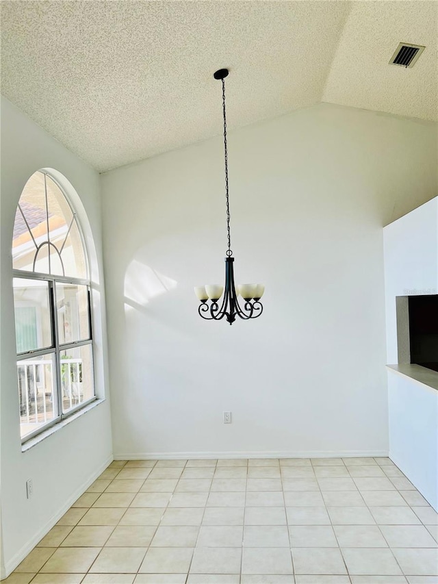 114 Clays Trl Unit 114, Oldsmar, FL 34677 - unfurnished dining area with plenty of natural light, a chandelier, a textured ceiling, and vaulted ceiling