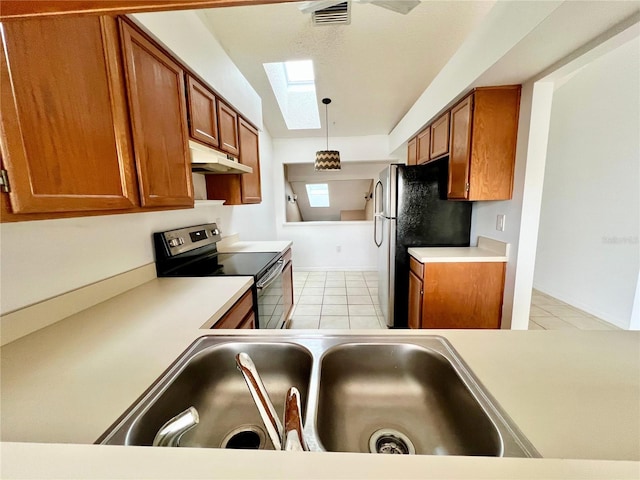 114 Clays Trl Unit 114, Oldsmar, FL 34677 - kitchen with stainless steel appliances, brown cabinetry, under cabinet range hood, and a sink