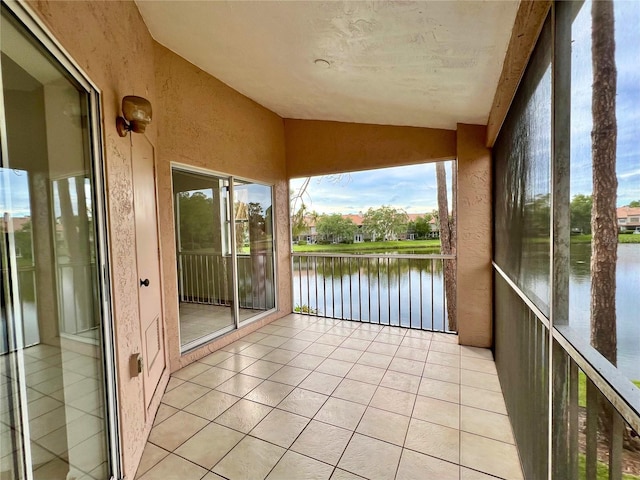 114 Clays Trl Unit 114, Oldsmar, FL 34677 - unfurnished sunroom with a water view, lofted ceiling, and tile patterned flooring