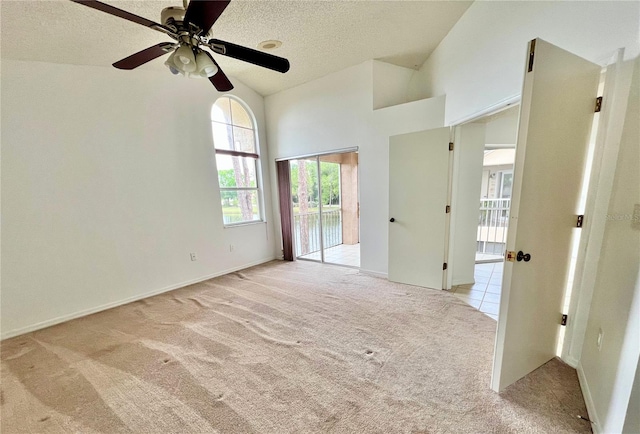 114 Clays Trl Unit 114, Oldsmar, FL 34677 - unfurnished room with light carpet, a ceiling fan, a textured ceiling, and lofted ceiling