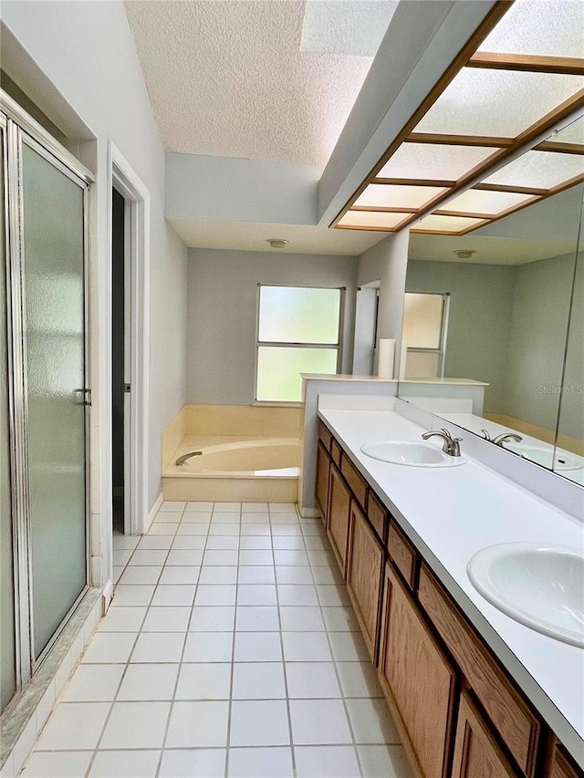 114 Clays Trl Unit 114, Oldsmar, FL 34677 - bathroom featuring a shower stall, a bath, tile patterned flooring, a textured ceiling, and double vanity