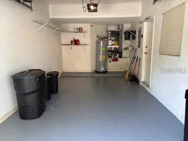 114 Clays Trl Unit 114, Oldsmar, FL 34677 - garage with electric water heater and a garage door opener
