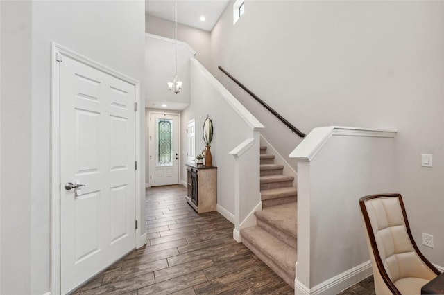 17537 Brighton Lake Rd, Land O Lakes, FL 34638 - entrance foyer with an inviting chandelier, stairs, baseboards, a towering ceiling, and dark wood-type flooring