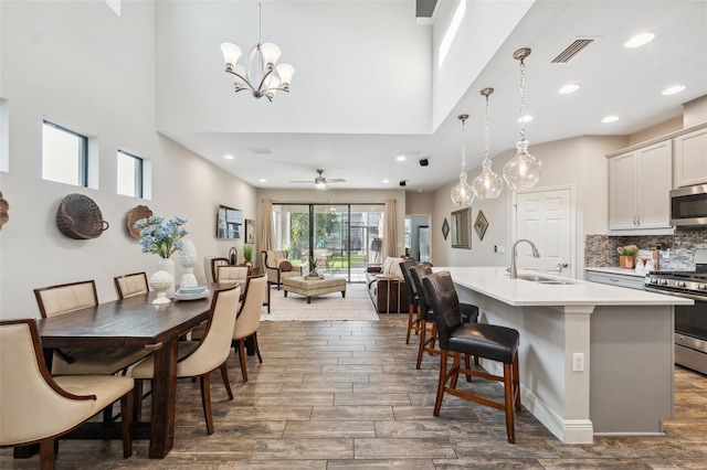 17537 Brighton Lake Rd, Land O Lakes, FL 34638 - kitchen featuring wood finished floors, a breakfast bar, light countertops, a sink, and stainless steel appliances