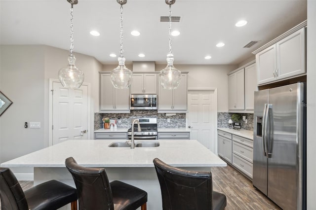 17537 Brighton Lake Rd, Land O Lakes, FL 34638 - kitchen with decorative backsplash, visible vents, appliances with stainless steel finishes, a sink, and dark wood-type flooring