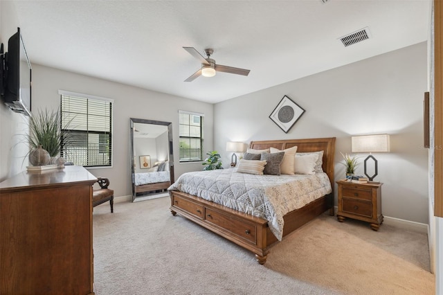 17537 Brighton Lake Rd, Land O Lakes, FL 34638 - bedroom with light colored carpet, baseboards, visible vents, and ceiling fan