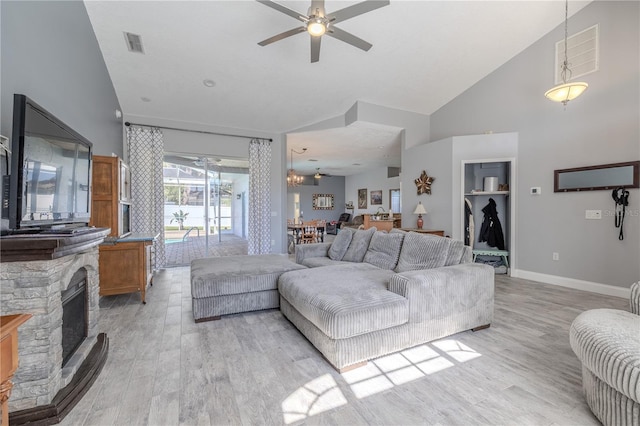 living room featuring high vaulted ceiling, baseboards, a ceiling fan, and light wood-type flooring