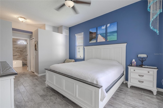 bedroom featuring connected bathroom, visible vents, multiple windows, and light wood-type flooring