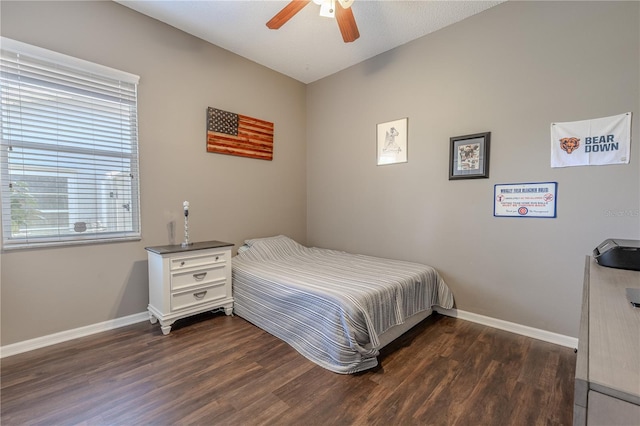 bedroom featuring baseboards, a ceiling fan, and dark wood finished floors