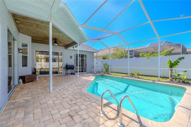 view of pool with fence, a fenced in pool, a ceiling fan, a patio, and a grill