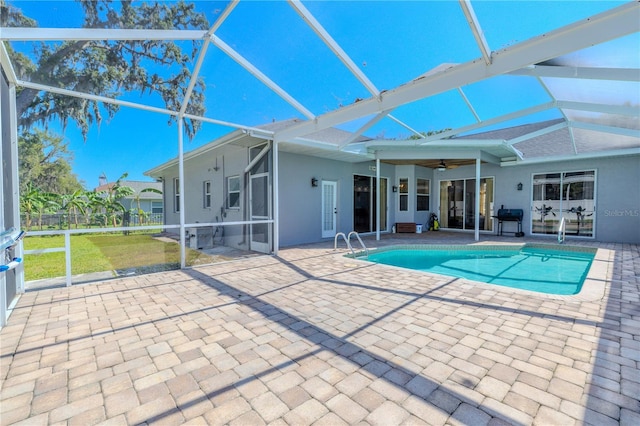 pool with a yard, a ceiling fan, a lanai, and a patio area