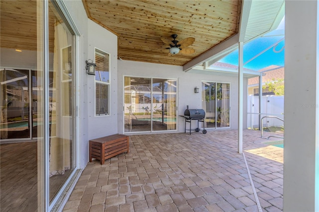 sunroom / solarium featuring ceiling fan