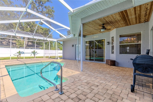 view of pool with fence, a patio, and ceiling fan