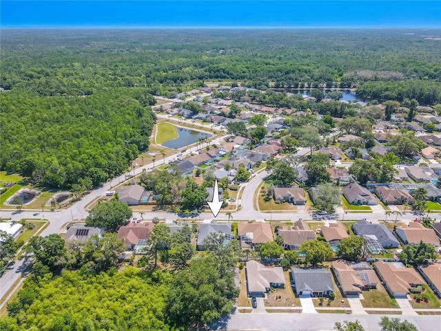 birds eye view of property featuring a water view, a view of trees, and a residential view