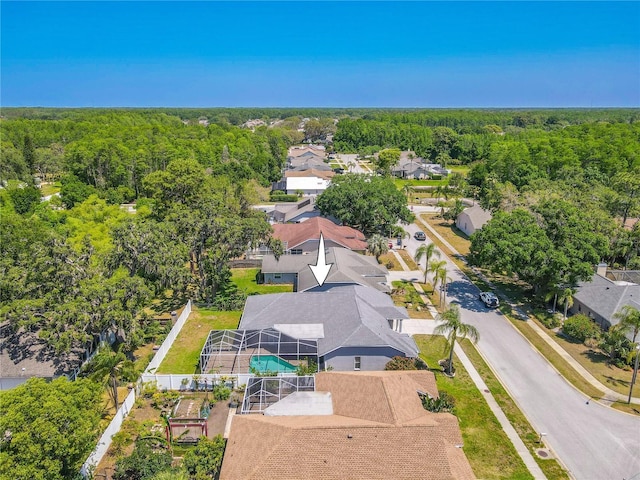 bird's eye view featuring a residential view and a wooded view