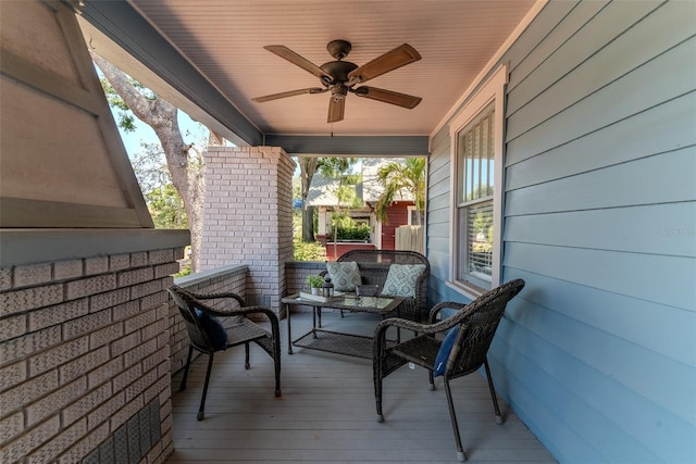 wooden terrace featuring a ceiling fan