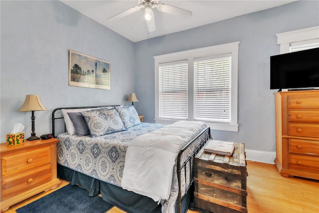 bedroom with baseboards, ceiling fan, and wood finished floors