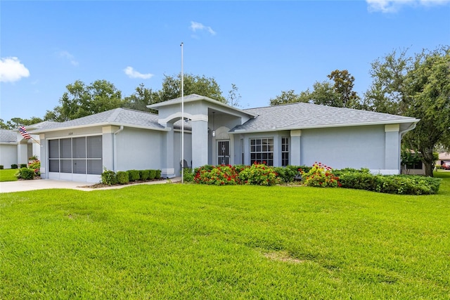 11218 Sun Tree Rd, Hudson, FL 34667 - view of front facade featuring a garage, a front lawn, stucco siding, and driveway