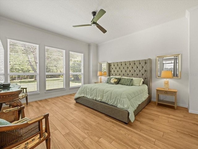 bedroom with baseboards, ceiling fan, and light wood finished floors