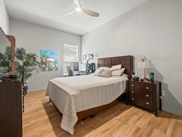 bedroom featuring baseboards, ceiling fan, and light wood finished floors