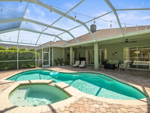view of pool featuring a patio, ceiling fan, and a pool with connected hot tub